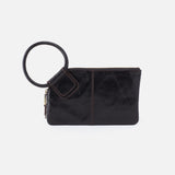 Black clutch bag with circular handle on a white background