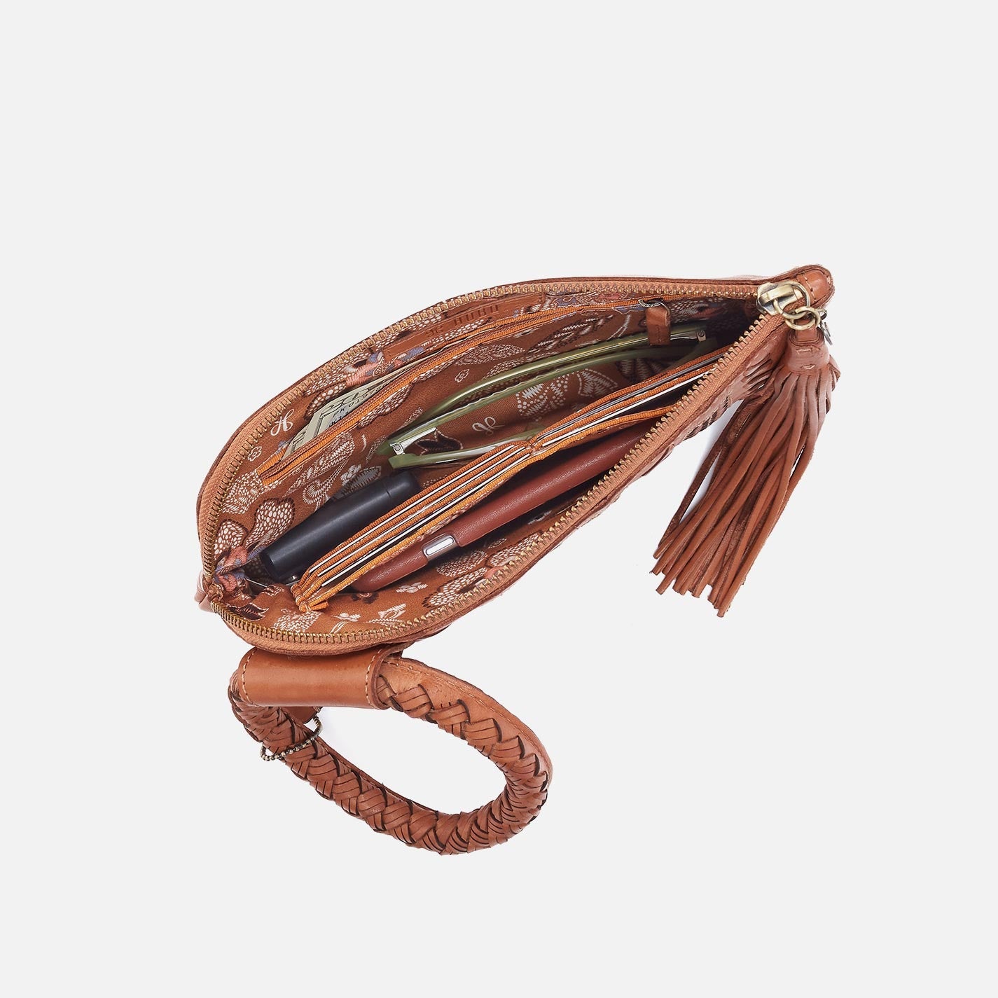 Brown leather clutch with tassel on a white background