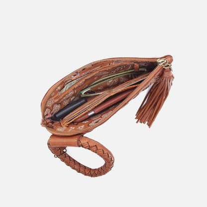 Brown leather clutch with tassel on a white background