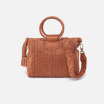 Brown woven handbag with circular handle on a white background