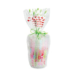 Packaged colorful straws with a decorative bow on a white background
