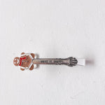 Decorative hair clip with a gingerbread man design and 'Make it Snappy' text on a white background
