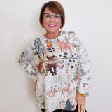 Woman wearing a patterned blouse with a white background