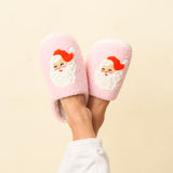 Pink slippers with Santa Claus design on a beige background