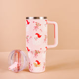 Pink travel mug with red fox design on a beige background