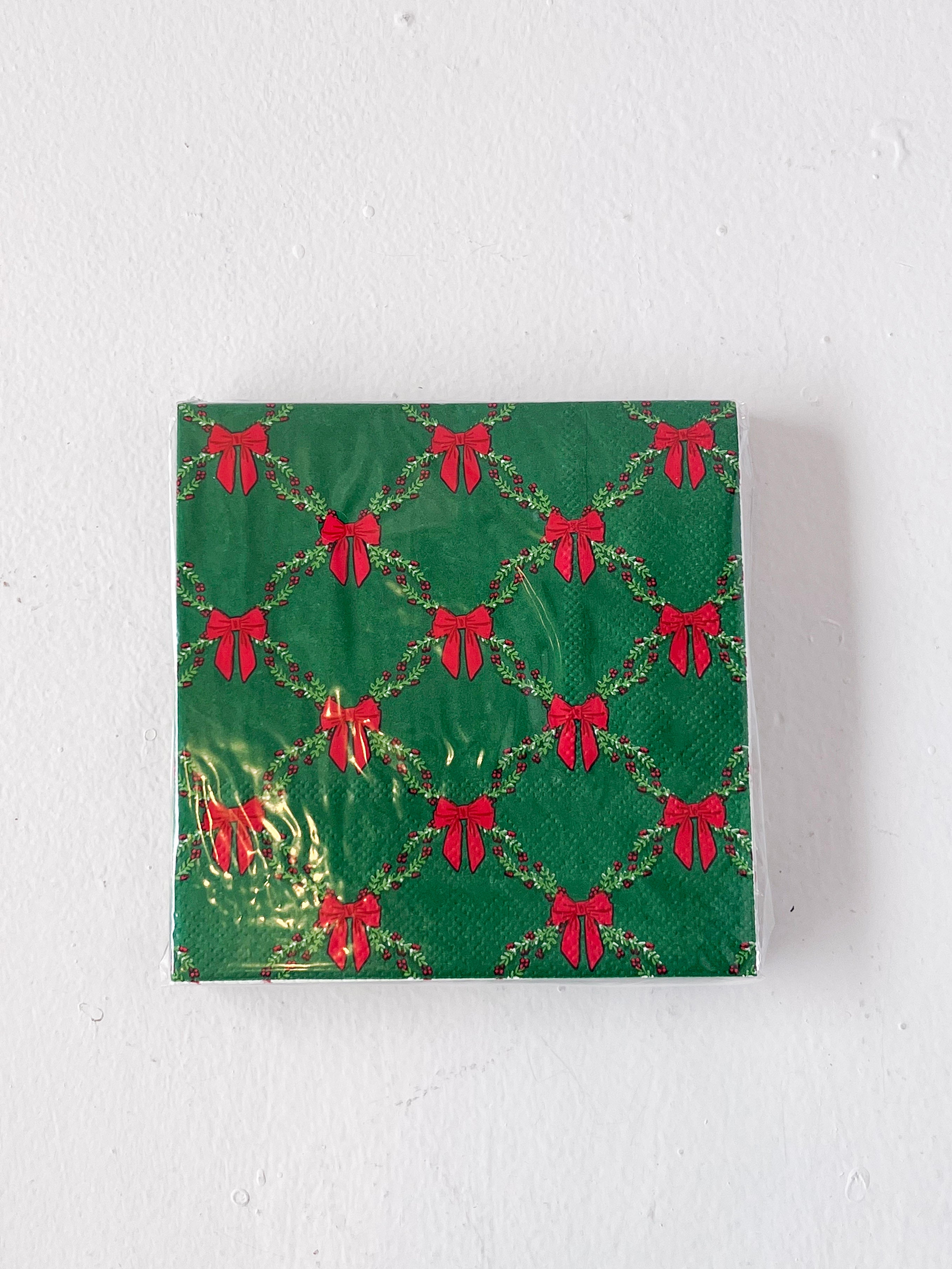 Green box with red bow pattern on a white background
