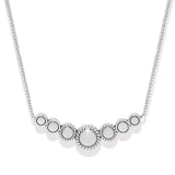 Silver necklace with circular pendants on a white background
