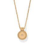 Gold necklace with a round pendant on a white background