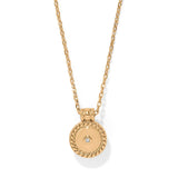 Gold necklace with a round pendant on a white background