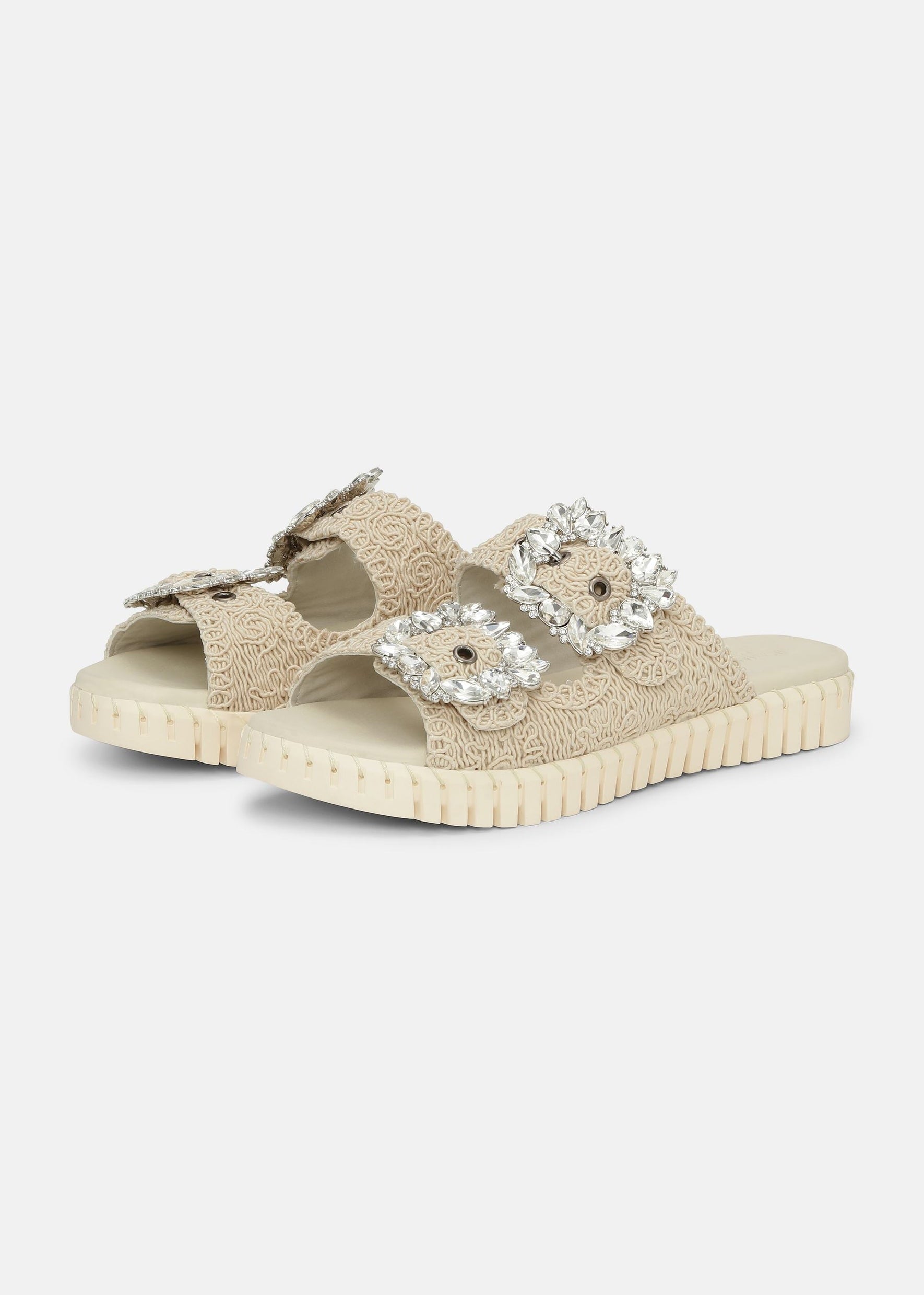 Beige sandal with embellishments on a white background