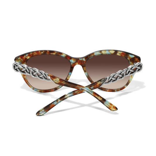 Sunglasses with tortoiseshell frame and chain detail on a white background