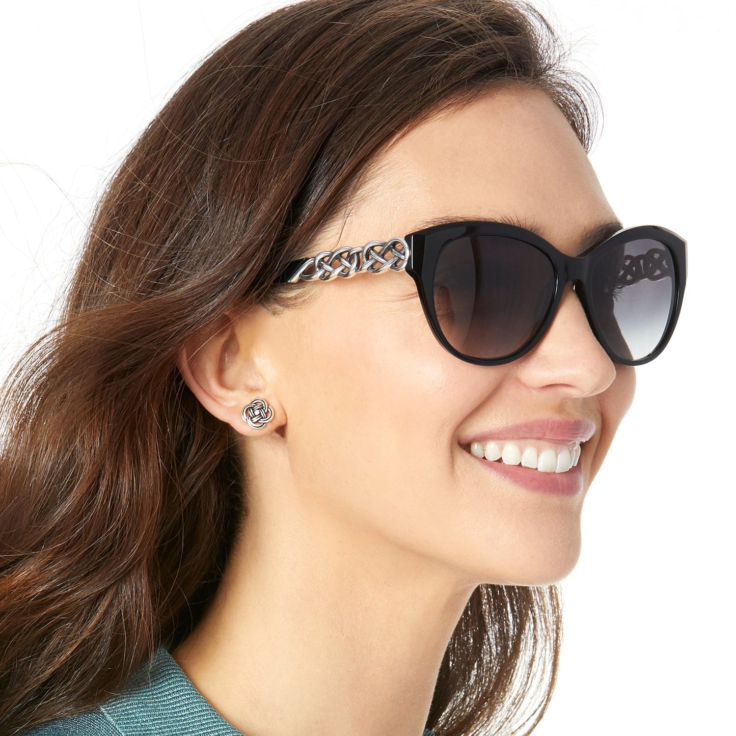 Woman wearing sunglasses with a decorative band, smiling.