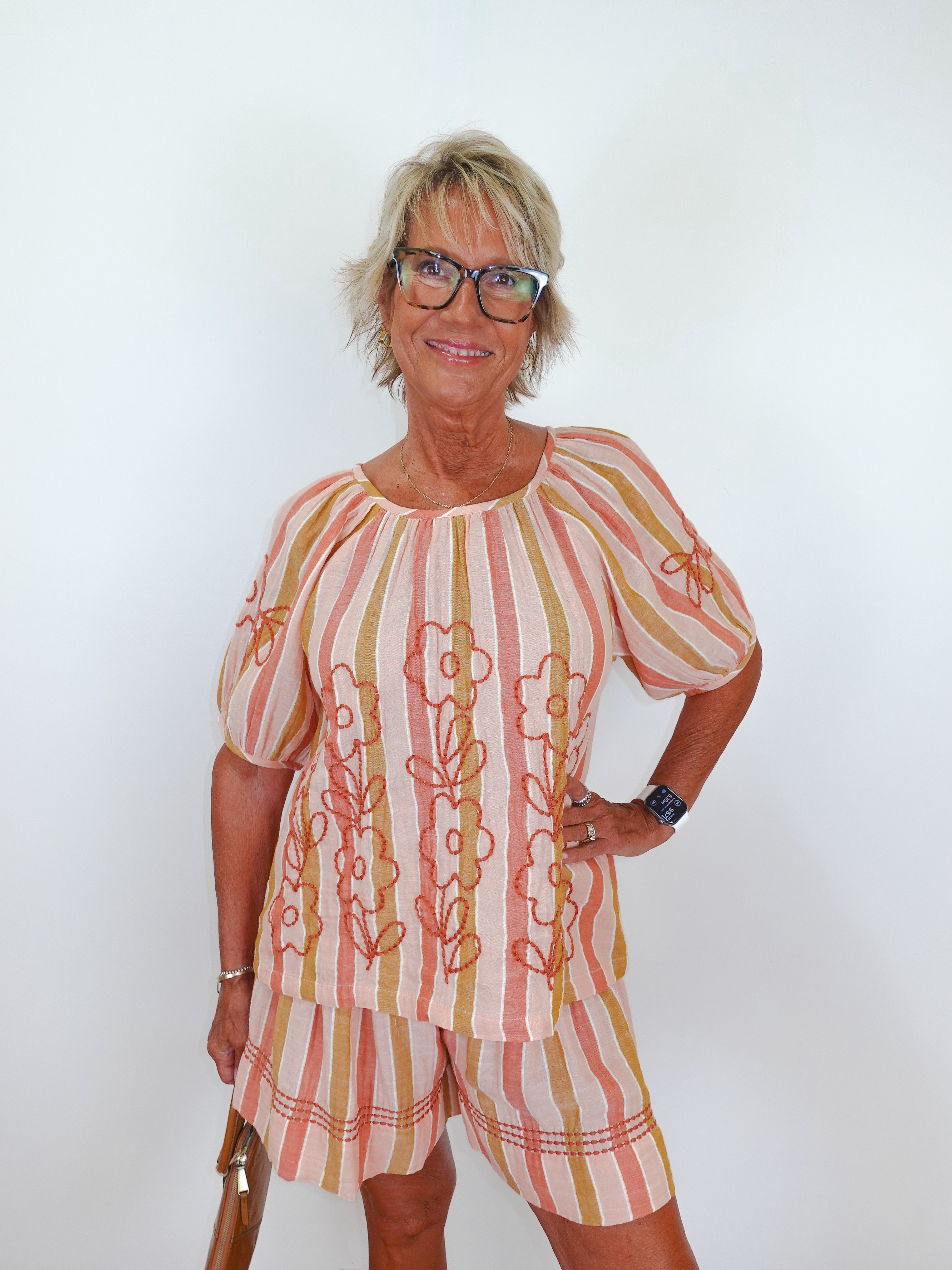 Woman wearing a patterned outfit with a white background