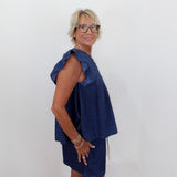 Woman wearing a blue dress against a white background