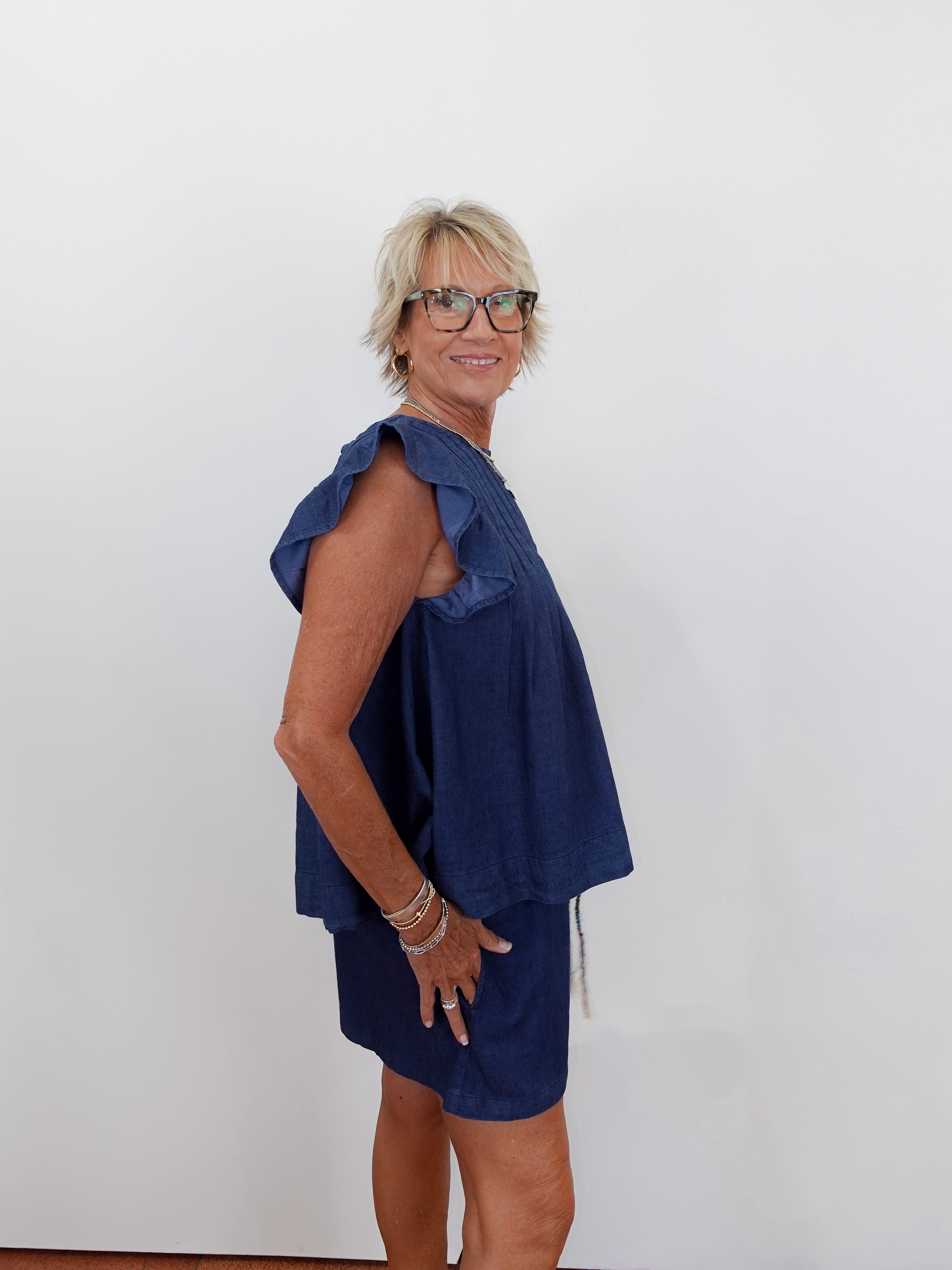 Woman wearing a blue dress against a white background