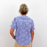 Person wearing a blue checkered shirt with a white background