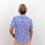 Person wearing a blue checkered shirt with a white background
