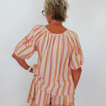 Woman wearing a striped dress with a white background