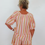 Woman wearing a striped dress with a white background
