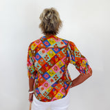 Person wearing a colorful patterned shirt with a white background