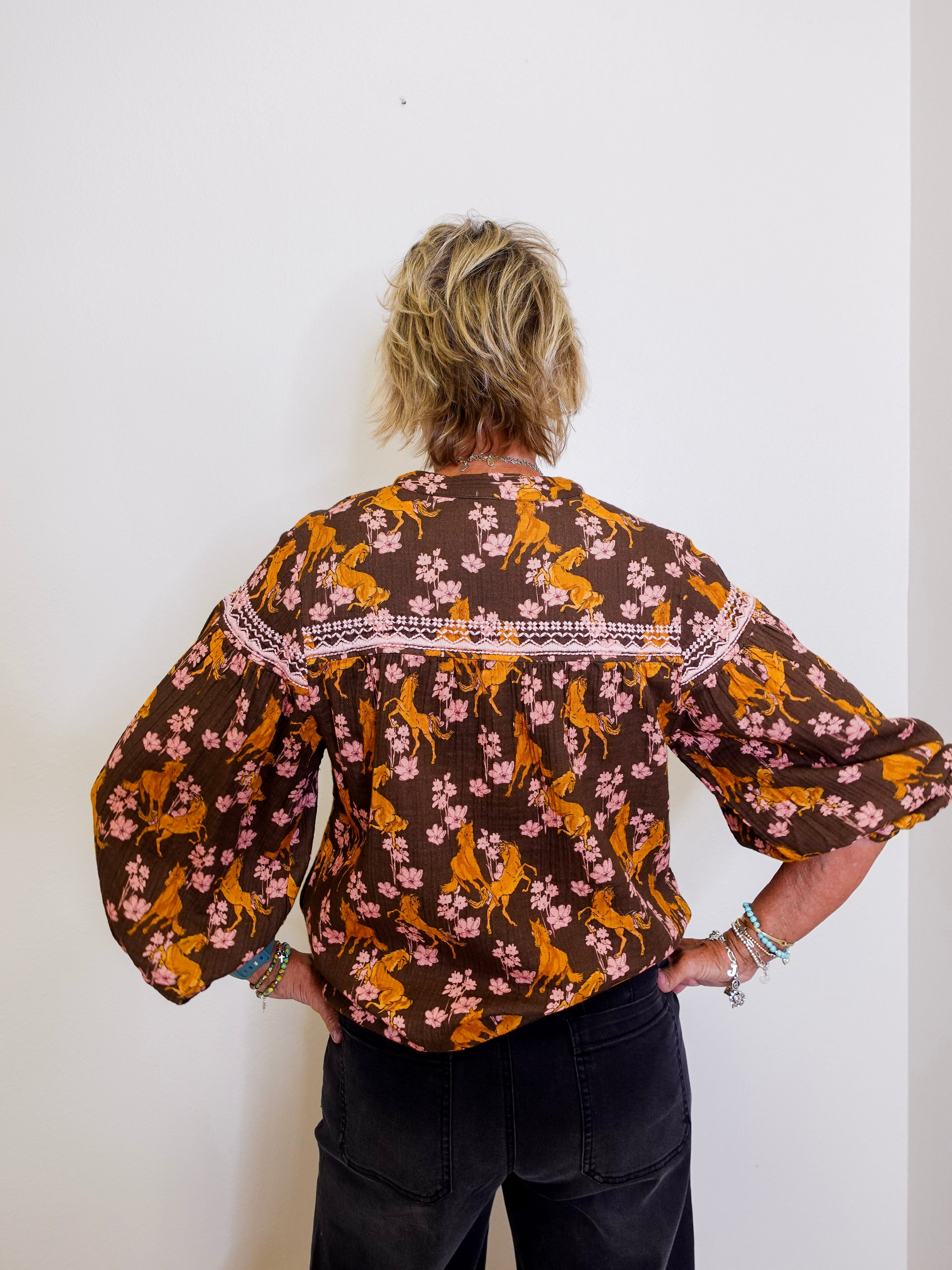 Person wearing a floral blouse with a white background