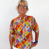 Person wearing a colorful patterned shirt with a white background