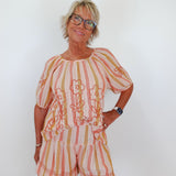 Woman wearing a striped outfit with a white background