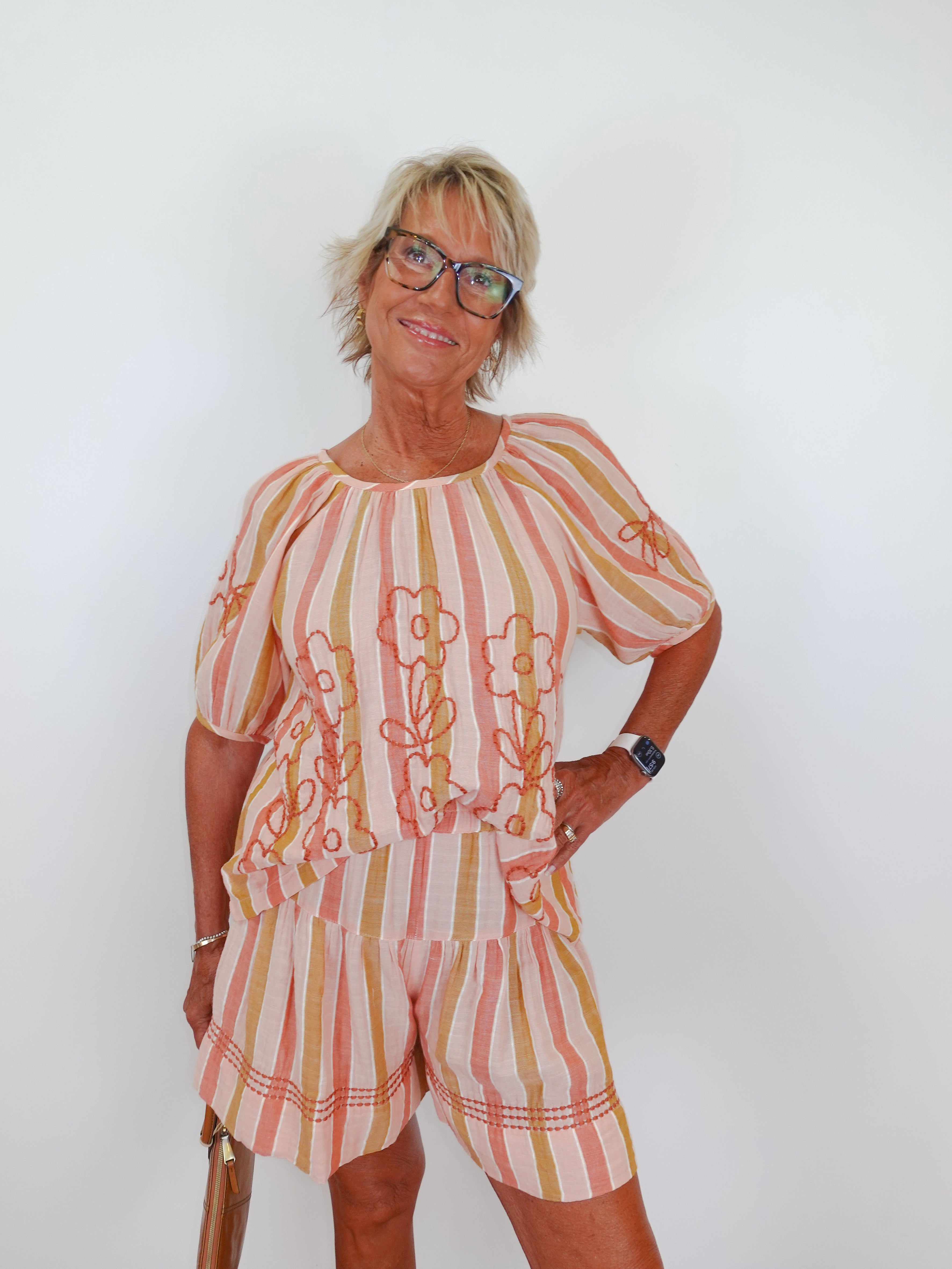 Woman wearing a striped outfit with a white background