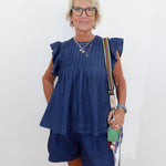 Woman wearing a blue outfit with a white background