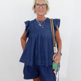 Woman wearing a blue outfit with a white background