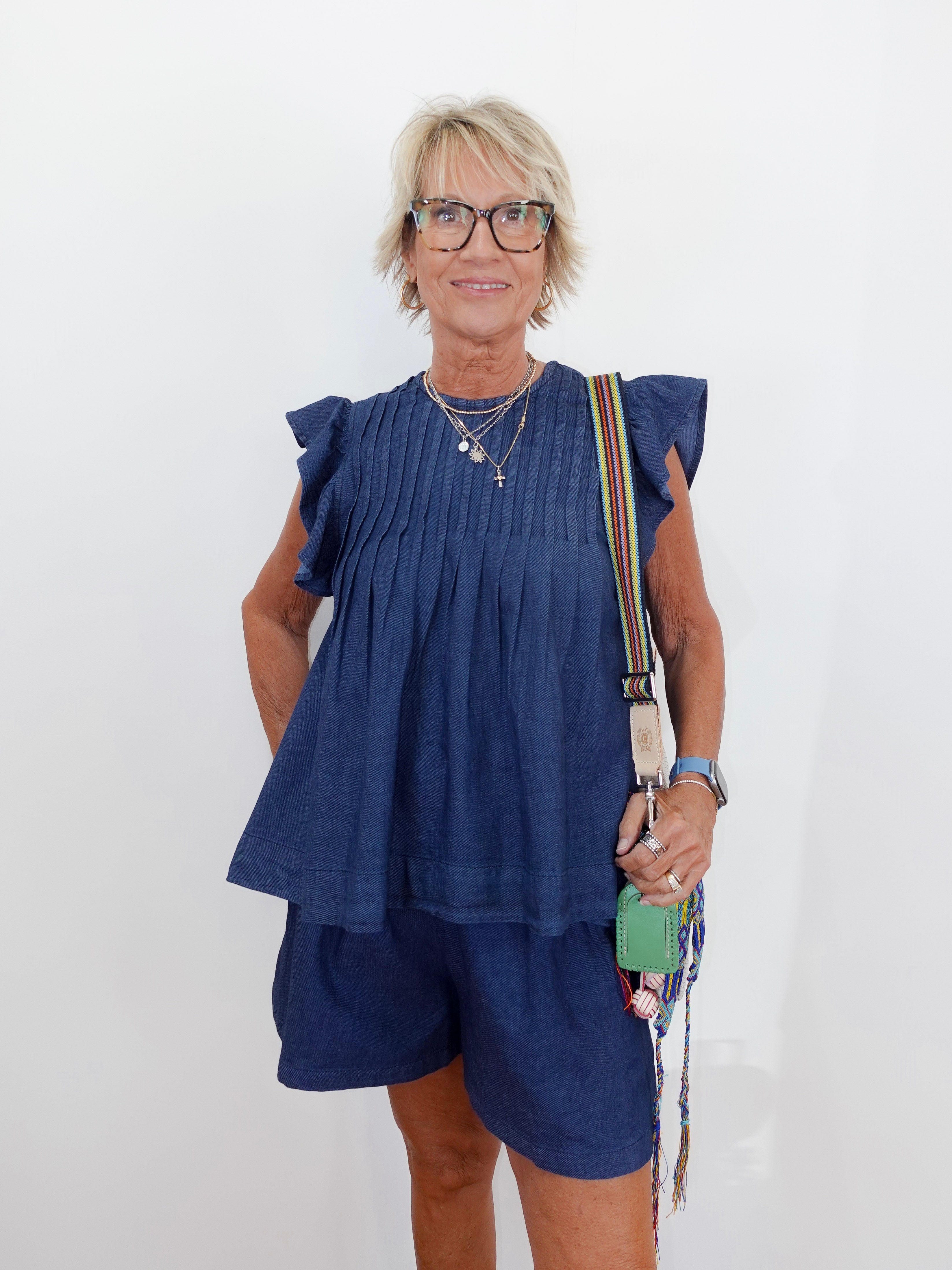Woman wearing a blue outfit with a white background