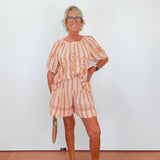 Woman wearing a colorful outfit with a white background