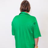Person wearing a green shirt against a white background