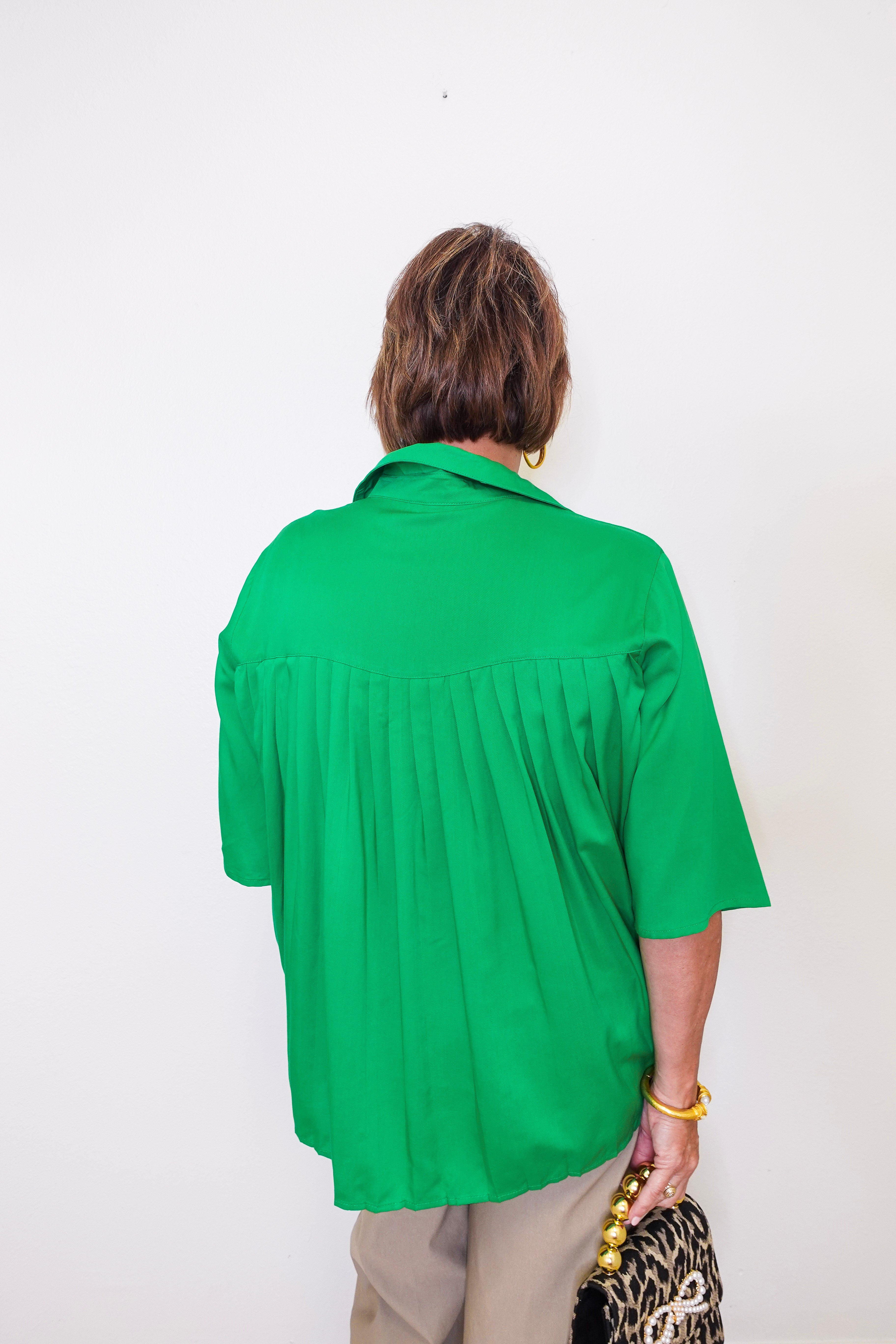 Person wearing a green shirt against a white background