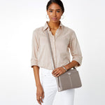 Woman holding a handbag against a white background