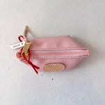 Pink pouch with a gold zipper and red string on a white background