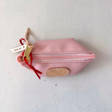 Pink pouch with a gold zipper and red string on a white background