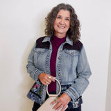 Woman holding a beige handbag against a white background