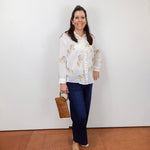 Model wearing the Johnny Was Cheval oversized shirt in white with gold horse print and button-front design.