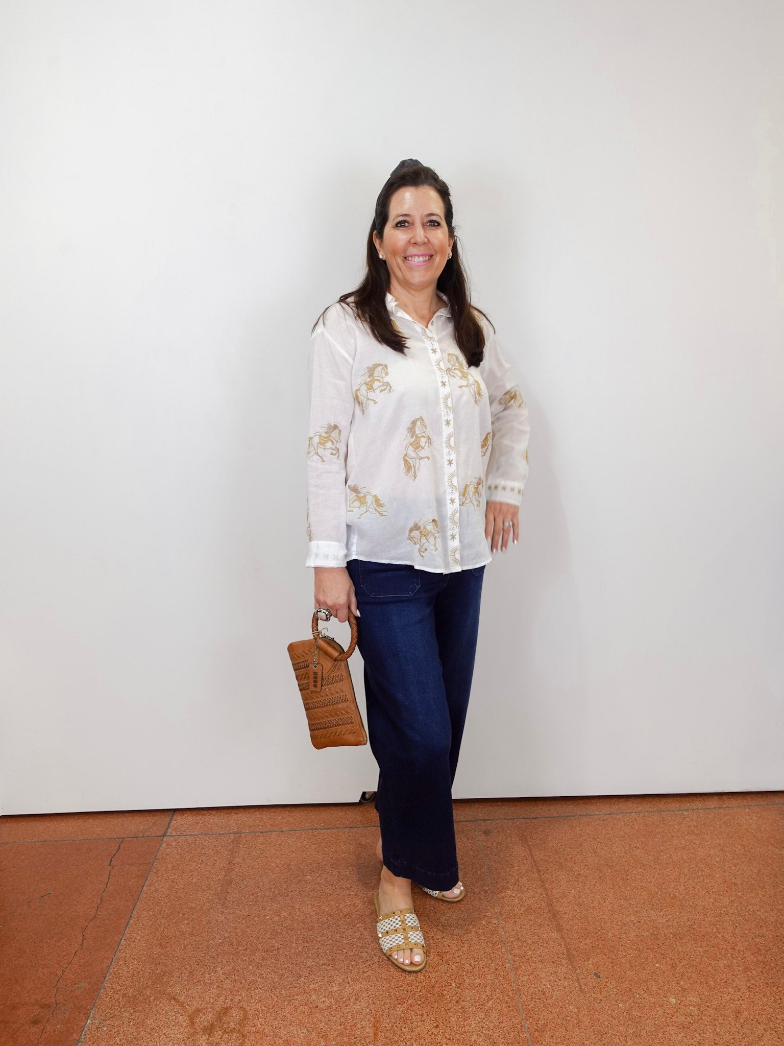 Model wearing the Johnny Was Cheval oversized shirt in white with gold horse print and button-front design.