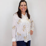 Model wearing the Johnny Was Cheval oversized shirt in white with gold horse print and button-front design.