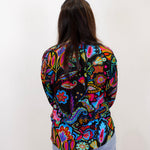 johnny was margot silvana blouse featuring vibrant multicolor paisley pattern worn with jeans