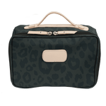 Green leopard print bag with beige accents on a black background