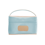 Light blue cosmetic bag with beige handle and patch on a white background