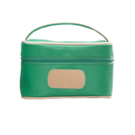 Green cosmetic bag with beige handle and patch on a white background