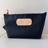 Black pouch with beige patch on a white background