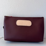 Burgundy  pouch with beige flap on a white background
