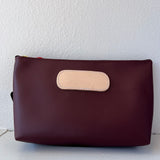 Burgundy  pouch with beige flap on a white background