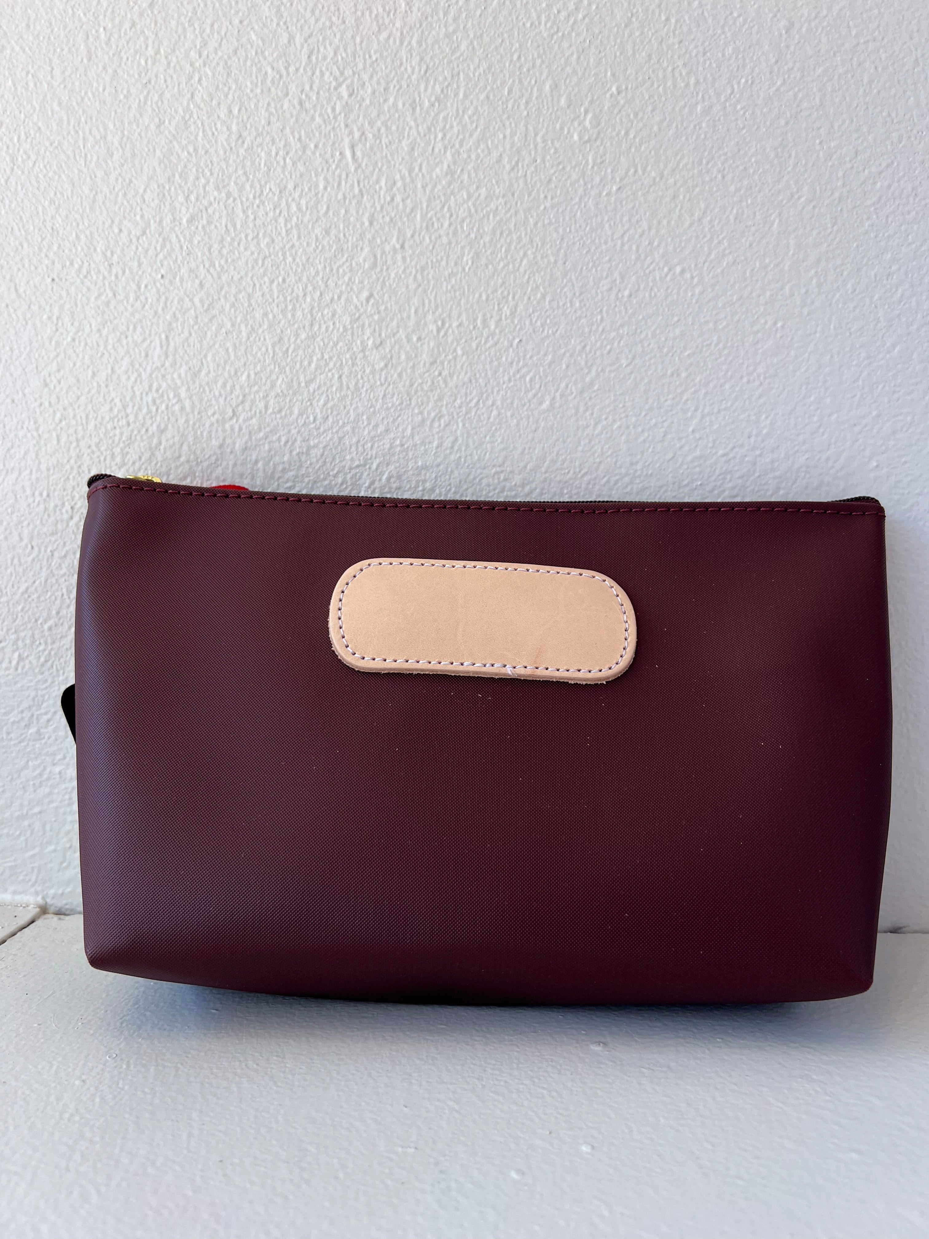Burgundy  pouch with beige flap on a white background