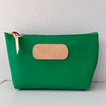 Green pouch with a beige patch on a white background